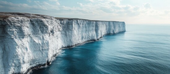 Majestic cliffs beautifully contrasting with the deep blue sea under a serene sky showcasing...