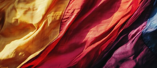 Obraz premium Colorful fabric folds representing joy and serenity capturing the essence of happiness through vibrant textile textures and warm hues