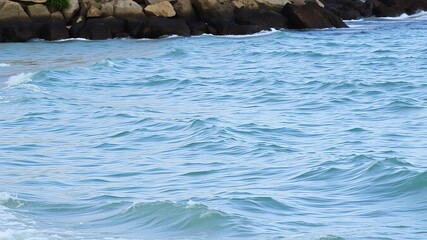 Fototapeta premium Serene ocean waves gently lapping against a rocky shoreline, water, scene, wave