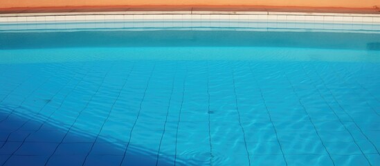 Obraz premium Repairing cracks in an aged lined resort swimming pool with clear blue water and reflections for restoration ideas and maintenance solutions