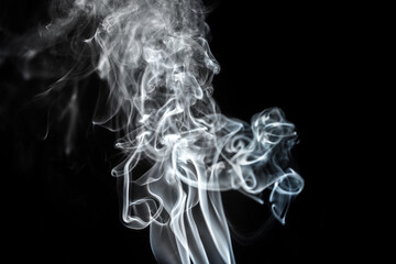 Ethereal wisps of smoke dancing in the darkness create a mesmerizing visual experience