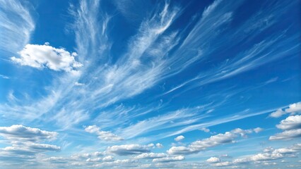 Thin wispy strands of cirrus cloud stretch out across a brilliant blue summer sky with just a few cotton-like tufts, wispy, cloudy, sunny day, atmosphere, scenery
