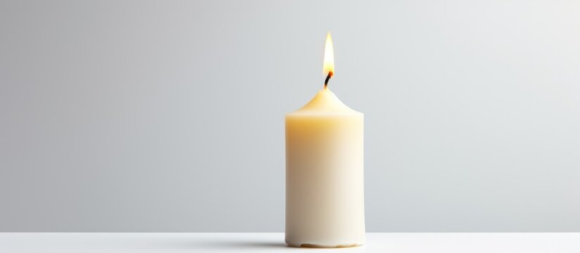 Birthday candle designed as a numeral illuminated against a neutral background for festive celebrations and milestone events