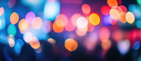 Fototapeta premium Colorful blurred lights creating a vibrant atmosphere of dancing crowds at a lively nightclub during a disco event