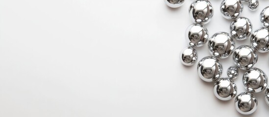 Shiny silver spheres arranged on a clean white background creating a minimalist and elegant aesthetic for contemporary design projects