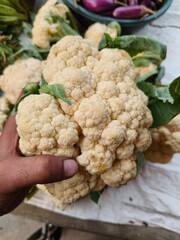 A customer purchasing fresh Cauliflower