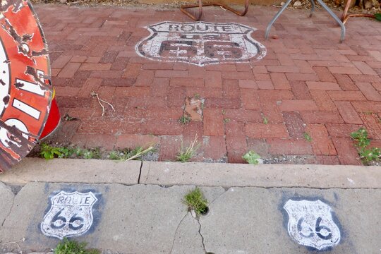 Route 66 Signs on the sidewalk outside The Sandhills Curiosity Shop., Erick, OK, USA. June 7, 2014. 