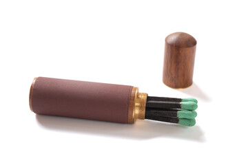 barrel-shaped matchbox with match sticks on white