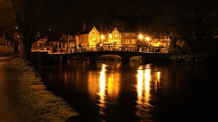Obraz premium A serene nighttime scene of a bridge and buildings reflecting in water.