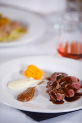 Ready to be eat, plate of cooked meat with sauces in side