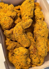 A box of Korean fried chicken with special Korean seasoning. Some pieces come with spicy sauce. Crispy and delicious.

