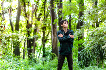 Man walking alone in deep forest and feel anxiety. Man feel nervously to walking alone in the forest