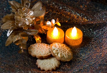 Christmas butter cookies burning candle and pine needles
