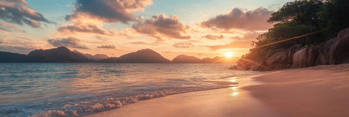 A breathtaking view of a beach at sunset with majestic mountains in the background, golden light gracing the horizon and peaceful ocean waves meeting the shore.