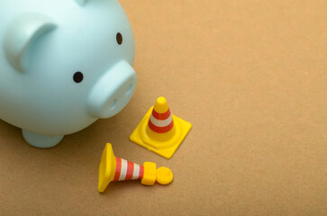 The traffic cones might symbolize obstacles or roadblocks that can hinder financial progress, such...