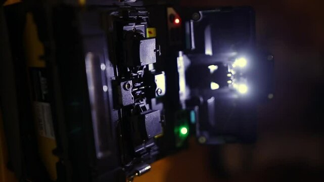 Close-up of specialized fiber optic splicing equipment. Fiber Optic Splicing Internet signal and wire connection by fiber optic splicing machine, fiber optic splicing machine. vertical video