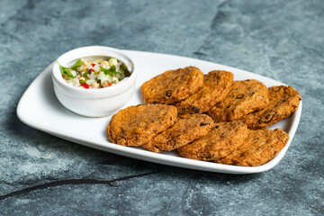 Fried Fish Cakes with salad served in tray dish isolated on grey background side view of thai food