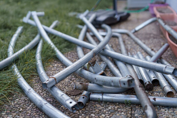 Disassembling and assembling the trampoline. The disassembled trampoline frame is prepared for storage.