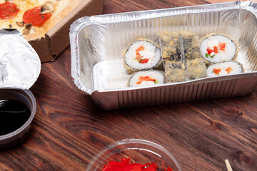 assorted baked rolls on a wooden background. Delivery of Asian food from a restaurant