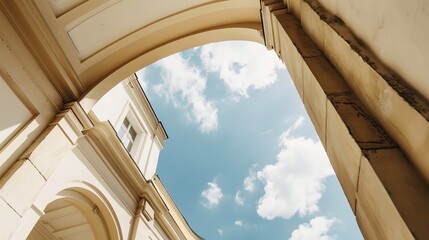 Obraz premium Arched Building with Sky - a harmonious blend of architecture and nature. The arched structure contrasts beautifully with the serene sky, creating a timeless and elegant scene.