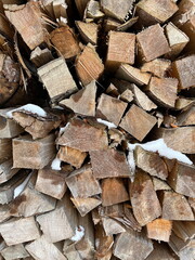 Closeup of woodpile with snow on it