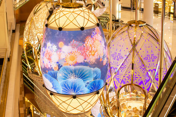 a chandelier with flowers and a sky in the background