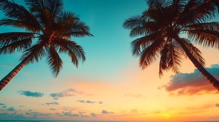A serene beach sunset with palm trees silhouetted against a vibrant sky filled with shades of orange, blue, and pink.