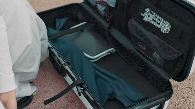 Archery, hands and person with quiver for sports preparation, packing gear and traditional martial arts. Japanese culture, arrow bag and getting ready on floor for tournament, competition or practice