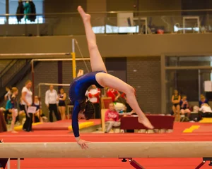 Fotobehang Gymnastiek Young gymnast girl performing routine on balance beam  © samards