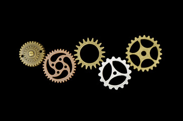 Connected different gear wheels isolated on black background. Partnership, cooperation, teamwork, community concept.