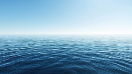 Obraz premium Calm ocean surface under a clear blue sky.
