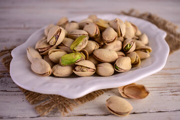 Hazelnuts in a plate on a white background.Close-up.
