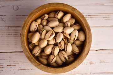 Hazelnuts in a wooden bowl. Flat lay.
