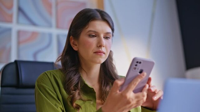Woman worried cellphone message working at modern office at laptop closeup.