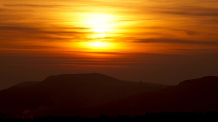 Red sunset on the mountain background . High quality photo
