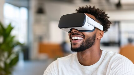 A cheerful man wearing a virtual reality headset, experiencing an enjoyable virtual world in a contemporary office setting with a bright, airy atmosphere.
