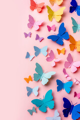Colorful paper cut butterflies on pastel pink background