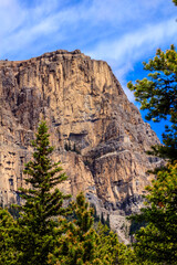 A mountain with a tree in front of it