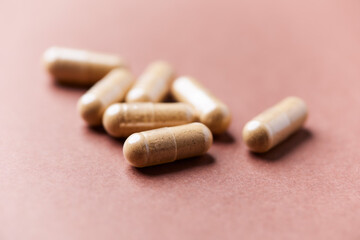 Korean Ginseng capsules. Concept for a healthy dietary supplementation. Bright paper background. Close up.	