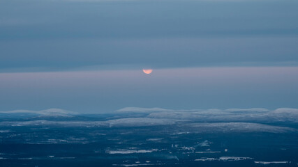 Moon partly hidden behind clouds. Part of the full moon