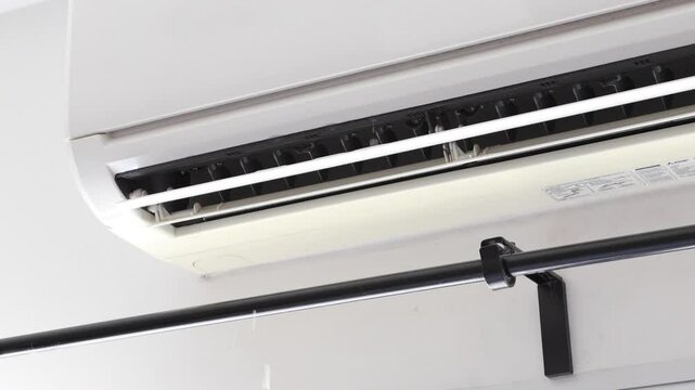 The broken air conditioner with water droplets.