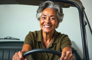 Happy Elderly Black woman with glasses, while holds a steering wheel, on light background, studio. Portrait of smiling elderly black female driver