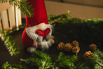 Obraz premium Christmas gnome to enhance your holiday decor Christmas advent decoration Concept for Christmas or New Year greeting card mock up. with copy space image. Place for adding text or design