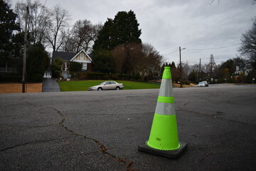 Bright Yellow Traffic Cone on Wide Residential Neighborhood Street