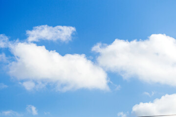 Bright blue sky with fluffy white clouds showcasing a clear day and serene atmosphere