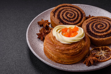 Sweet dessert danish covered with white cream and citrus, with cream filling
