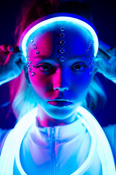 Stunning lady touch wear neon glitter cable crown looking over augmented colorful fluorescent background