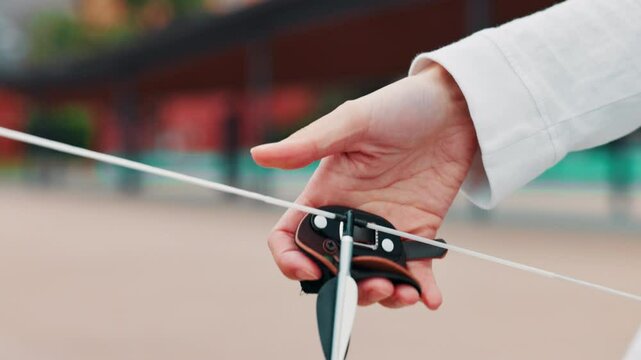Archery, bow and arrow with hands in Japan for shooting game, challenge and target practice. Competition, training and draw weapon with sports gear and person closeup for score, aim or bullseye