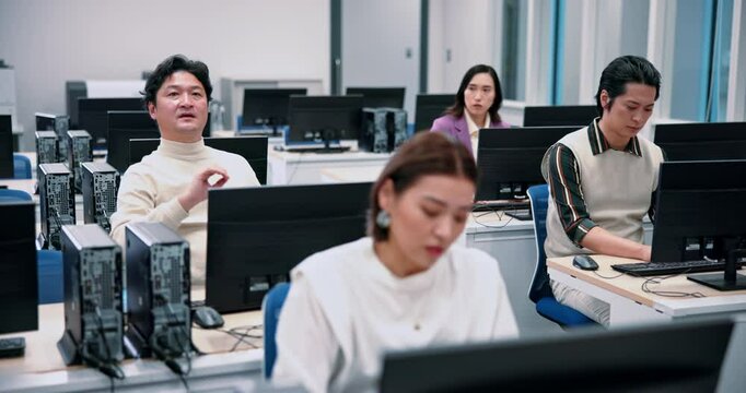 Japanese man, question and computer science in lab for lesson, education and learning for degree. Group, people and technology in university or college for program, language and scholarship in school