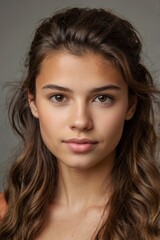 Naklejka premium young woman with long wavy brown hair and brown eyes